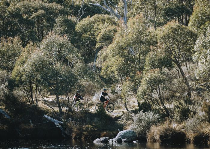 Couple enjoying a day of mountain biking on the Thredbo Valley Track in Kosciuszko National Park, Snowy Mountains